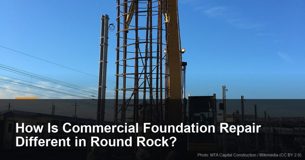 Workers guiding a rebar cage onto a foundation site — Round Rock, TX foundation repair